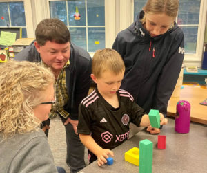 Maddie, Sam, and Mabel Kaler look on as first grader Angus Kaler works on a building challenge with his family during the Southport Central School's open house Sept. 26. (Photo courtesy Southport Central School)