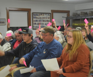 Alna residents vote to approve article six of their special town meeting warrant at the Alna fire station meeting room on Friday, Nov. 1. Article six, the most contentious item on the warrant, allows the town to spend up to $167,000 on matching an around $835,000 grant from the Maine Department of Transportation for the replacement of the Ben Brook culvert on Egypt Road. (Nolan Wilkinson photo)