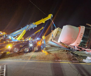 A tow truck lifts the empty trailer from the crash scene at the northern intersection of Route 1 and Main Street in Damariscotta on Monday, Nov. 18. According to a preliminary police report, a 44-year-old Florida man was operating the 2018 Freightliner southbound on Route 1 when he attempted to make a left turn onto Main Street around 6:30 p.m. The crash closed part of the road for more than four hours. (Courtesy photo)