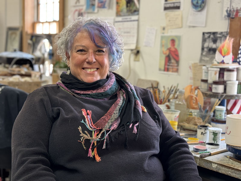 Mindy Star-Pfahler sits in the Sheepscot River Pottery studio in Edgecomb on Monday, Nov. 11. Star-Pfahler, of Nobleboro, taught art to students K-8 for 26 years in New Jersey before moving to Maine in 2013 with her husband. She continues to teach art at the CLC YMCA and has been a member of the Damariscotta Pumpkinfest and Regatta committee since 2018. (Johnathan Riley photo)