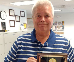 Stanley "Stan" Waltz holds his Code Enforcement Officer of the Year plaque from the Midcoast Code Enforcement Officers Association in 2017. (LCN file photo)