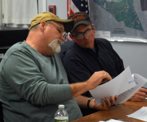 Newly elected Somerville Select Board Chair Willard Pierpont (left) looks through correspondence with fellow select board member Don Chase. Pierpont was elected by a 2-0 vote Wednesday, Nov. 20. He and Chase will remain the only members of the board until townspeople elect a third select board member in a special election set for Tuesday, Jan. 7. (Molly Rains photo)