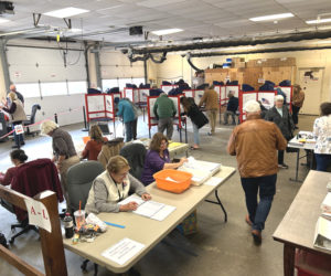 Waldoboro ballot clerks and voters congregate in the garage of the Waldoboro municipal building midday on Tuesday, Nov. 5. (Molly Rains photo)