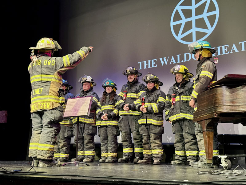 Waldoboro Fire Chief Paul Smeltzer (left) directs fellow firefighters for a handbell rendition of Mary Had a Little Lamb during the Waldoboro Talent Show on Saturday, Nov. 2 at The Waldo Theatre. (Johnathan Riley photo)