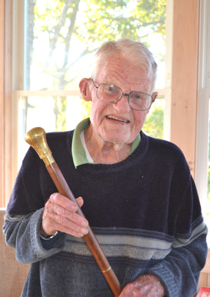 Dr. Barclay Shepard, a 22-year Navy veteran, proudly holds Boothbay Harbor's Boston Post Cane, presented to him in honor of his status as the oldest citizen in town. (Charlotte Boynton photo)