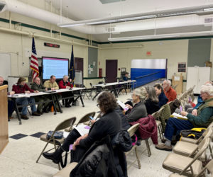 Damariscotta residents sit in the Great Salt Bay Community School cafeteria during a special town meeting on Tuesday, Dec. 10. Voters approved all articles on the warrant, which included allocating funds for electric vehicle chargers in the municipal back parking lot, amendments to the shoreland zoning ordinance, and the acceptance of a new comprehensive plan. (Johnathan Riley photo)