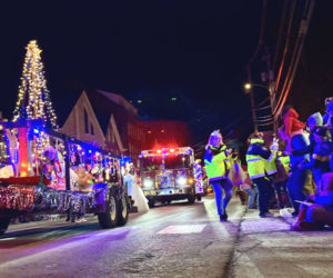 The Parade of Lights makes its way down Main Street in Damariscotta on Saturday, Nov. 30 while participants hand out holiday goodies to the crowd lining the street. (Johnathan Riley photo)