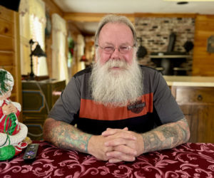 Steve Hendrix, of Bristol, sits in his home on Snowball Hill Road on Friday, Dec. 6. Hendrix, an employee of the Bristol Parks and Recreation Department, has owned his own auto repair shop, sheep farm, and antique motorcycle business. During the winter months, Hendrix travels New England, helping out Santa Claus. (Johnathan Riley photo)