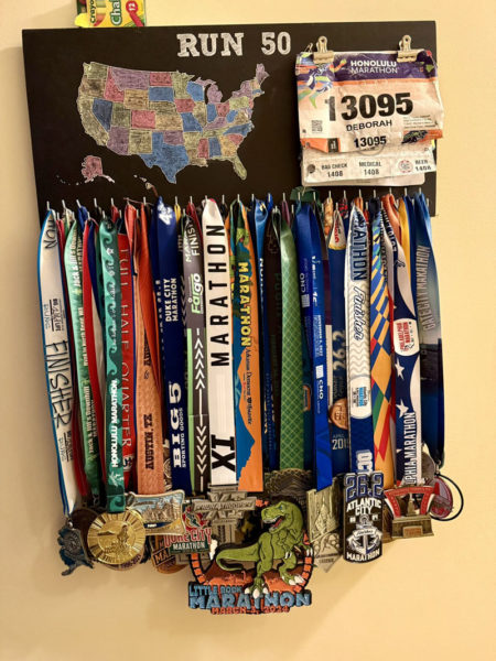 Both Deb Taylor and Andrea Di Benedetto kept a medal board while completing their 20-year quest to run a marathon in every state. Included are their marathon medals, bib numbers, and map of the United States, which they colored in after completing a state. (Courtesy photo)