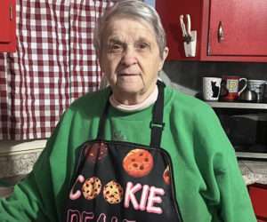 Nancy Dedrick wears her favorite apron in the kitchen of her Newcastle home on Dec. 26. Dedrick, who was born and raised in Newcastle, has spent the last 40 years making baked goods for local businesses and friends. "I love making people happy," she said. "It's what you give in life, not what you get back." (Piper Pavelich photo)