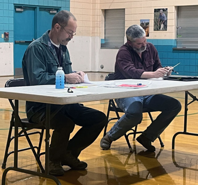 AOS 93 Board members Wayne Parlin (left) and Matthew Benner review a revised central office budget during a meeting Tuesday, Jan. 14. The proposed $1,094,247.32 budget will be considered by residents of Bristol, Jefferson, Nobleboro, and South Bristol on Wednesday, Jan. 22. (Piper Pavelich photo)