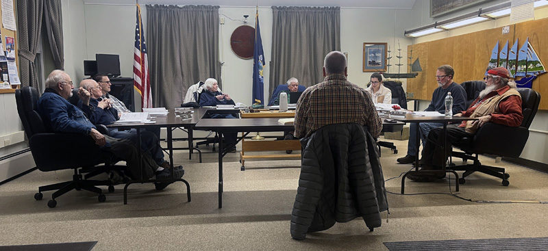 Priority Real Estate Group's Vice President of Engineering Curtis Neufeld (center) discusses Tucker Chevrolet's plan to relocate from Waldoboro to Wiscasset with the Wiscasset Planning Board during a meeting the evening of Dec. 23. The dealership will be located at 771 Bath Road, opposite Norm's Used Cars. (Piper Pavelich photo)