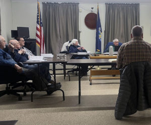 Priority Real Estate Group's Vice President of Engineering Curtis Neufeld (center) discusses Tucker Chevrolet's plan to relocate from Waldoboro to Wiscasset with the Wiscasset Planning Board during a meeting the evening of Dec. 23. The dealership will be located at 771 Bath Road, opposite Norm's Used Cars. (Piper Pavelich photo)