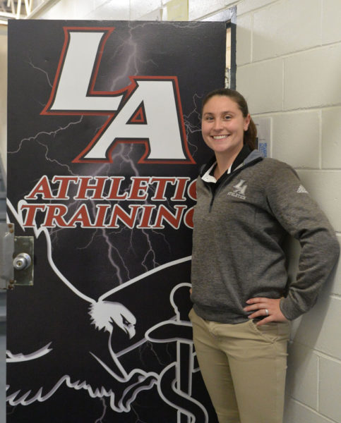 Lincoln Academy athletic trainer Megan Day stands in front of her office door in Newcastle. Day joined the school full time in fall 2015. (Paula Roberts photo)