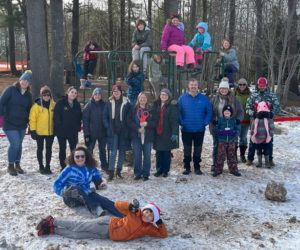 Parents and staff of Damariscotta Montessori School in Nobleboro hold a small ribbon-cutting ceremony in December to celebrate the addition of four new pieces of equipment the schools playground. The schools students took the initiative to plan and engage in their own fundraising for the equipment, raising more than $200 on their own. (Photo courtesy Damariscotta Montessori School)