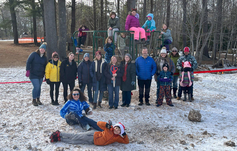 Parents and staff of Damariscotta Montessori School in Nobleboro hold a small ribbon-cutting ceremony in December to celebrate the addition of four new pieces of equipment the schools playground. The schools students took the initiative to plan and engage in their own fundraising for the equipment, raising more than $200 on their own. (Photo courtesy Damariscotta Montessori School)