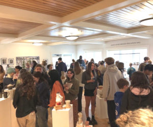 A large crowd of students and their supporters take in the Lincoln Academy student art show at Coastal Rivers Land Trust in Damariscotta on April 11. The annual event features ceramics, jewelry, and 2D art from over 50 high school students. (Sarah Masters photo)