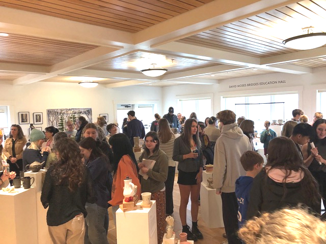 A large crowd of students and their supporters take in the Lincoln Academy student art show at Coastal Rivers Land Trust in Damariscotta on April 11. The annual event features ceramics, jewelry, and 2D art from over 50 high school students. (Sarah Masters photo)