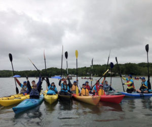 Paddlers salute during Hearty Roots Paddle for a Purpose event in 2023. (Photo courtesy Hearty Roots)