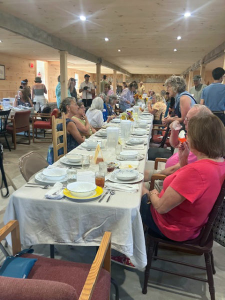 Inn Along the Way's long barn fills for the Community Plate story-sharing potluck. (Courtesy photo)