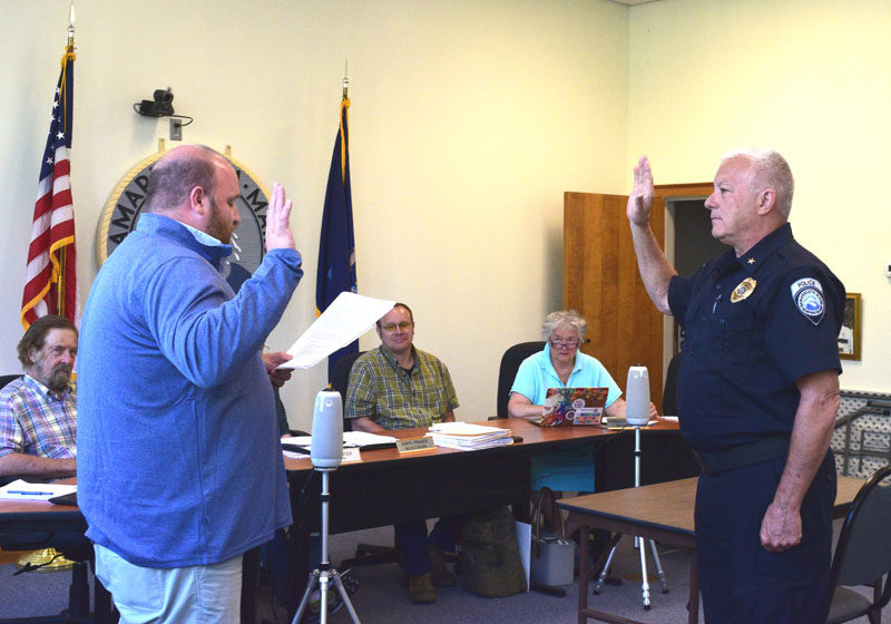Damariscotta Town Manager Andy Dorr swears in Phil Tessier as the town's interim police chief on Wednesday, Aug. 6. Tessier retired in April after serving as a full-time officer for the town's police department. (Ali Juell photo)