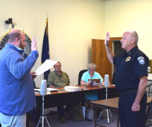 Damariscotta Town Manager Andy Dorr swears in Phil Tessier as the town's interim police chief on Wednesday, Aug. 6. Tessier retired in April after serving as a full-time officer for the town's police department. (Ali Juell photo)
