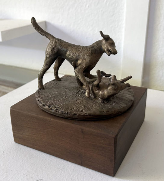 "Dogs wrestling," a bronze statue by Monhegan sculptor Daphne Pulsifer, is displayed inside her studio on Light House Road on the island. Pulsifer said dogs often appear in her work. (Molly Rains photo)