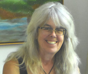 Sculptor Daphne Pulsifer laughs at a work station inside her studio on Light House Road on the island of Monhegan. Pulsifer and her husband raised small children on the island, and she has shaped her identity as a sculptor amidst the community of artists there, she said. (Molly Rains photo)
