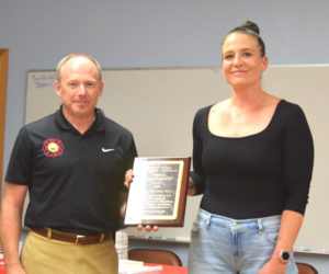 Waldoboro Fire Chief Paul Smeltzer presents Hannah Meneses with the Citizen Life Saving Award during the Lincoln County Fire Chiefs Associations annual meeting on Wednesday, Aug. 20 in South Bristol. Meneses received the award for her actions on March 28 when she exhibited exceptional courage and quick thinking to save a man trapped in a sinking vehicle in Davis Stream in Jefferson. (Christina Wallace photo)