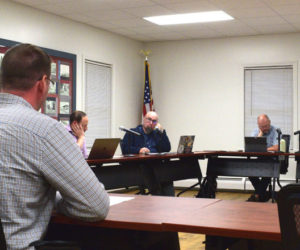 Carl Ayers (left), of engineering consulting firm VHB, reviews contractor bids for the Lynch Road construction project with the Newcastle Select Board during a meeting on Monday, Sept. 25 meeting. (Ali Juell photo)