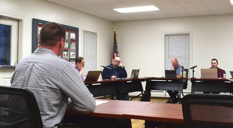 Carl Ayers (left), of engineering consulting firm VHB, reviews contractor bids for the Lynch Road construction project with the Newcastle Select Board during a meeting on Monday, Sept. 25 meeting. (Ali Juell photo)