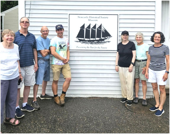 Newcastle Historical Society board members celebrate a recently installed replacement sign designed and created in collaboration with Lincoln Academy faculty member for ATEC, Andrew Jonash. From left: Sandra Barth, Tim Dinsmore, Mike Titus, Andrew Jonash, Karen Campbell, Betsy Evans, and Karen Paz. Not pictured: Bruce Campbell and Arlene Cole. (Photo courtesy Newcastle Historical Society)