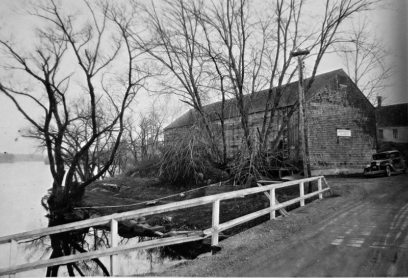 The former ice house at Damariscotta Mills overlooks Damariscotta Lake. The sign on the front of the house says, "Jones Coal & Ice Co., G.H. Melville." This was the previous location of the Gorham House. The land now belongs to the town of Nobleboro and is known as "the ice house lot." (Photo courtesy Nobleboro Historical Society)