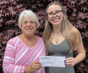 The inaugural Shirley Gallagher Memorial Nursing Scholarship recipient Madison Holmes (left) accepts her award from Miles Memorial Hospital League Board Chair Ann McFarland. (Photo courtesy Trudy Reilly)