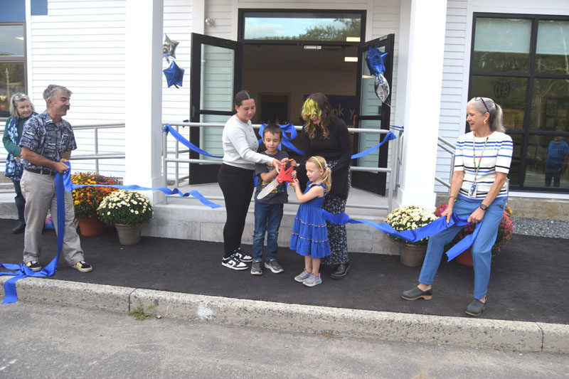 Bristol Consolidated School students Maisy Gilbert, George Reny, Audrey Bourne, and Calliope Phillips cut the ribbon held by Bristol School Committee Chair Darin Carlucci and BCS Principal Jennifer Ribeiro during a celebration on Thursday, Sept. 11. From left: Darin Carlucci, Maisy Gilbert, George Reny, Audrey Bourne, Calliope Phillips, and Jennifer Ribeiro. (Christina Wallace photo)
