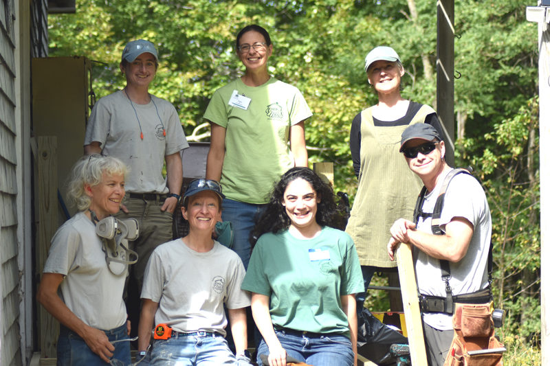 During a site visit by Community Housing Improvement Project Executive Director Brittany Gill, Community Cares Day volunteers pause while building a handicapped-accessible ramp at a Whitefield residence. The ramp was one of 16 scheduled projects on 15 different sites scattered around Lincoln County Saturday, Sept. 13. Front row, from left: Sarah Highland, Hannah McGhee, Elizabeth Schwartz, and Randy Domina. Back row, from left: Laura Sofen, Brittany Gill, and Angela Kortemeier. (Sherwood Olin photo)