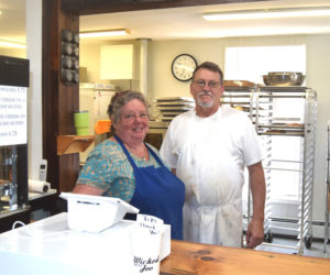 Owners Karen and John Kelly stand behind the counter of Savory Moose on East Pond Road in Nobleboro. Having previously closed the business then named Ginger Mousse Bakery in September 2024, the Kellys have come out of retirement and reopened with a new name, new menu, and new hours. (Christina Wallace photo)