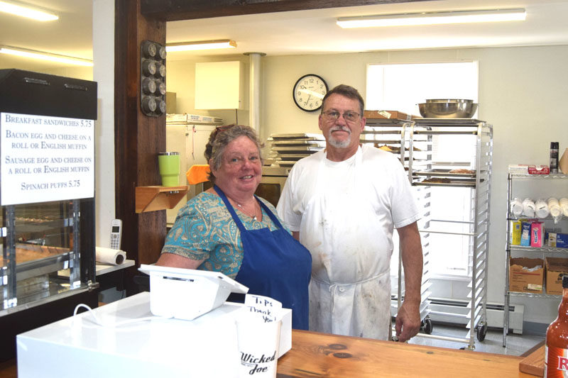Owners Karen and John Kelly stand behind the counter of Savory Moose on East Pond Road in Nobleboro. Having previously closed the business then named Ginger Mousse Bakery in September 2024, the Kellys have come out of retirement and reopened with a new name, new menu, and new hours. (Christina Wallace photo)