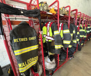 Dick Glidden's turnout gear hangs in his locker at the Waldoboro fire station next to the gear of Waldoboro's active firefighters on Saturday, Sept. 20. Glidden passed away Sept. 16, five days after he was diagnosed with terminal cancer. (Photo courtesy Shawna Kurr)