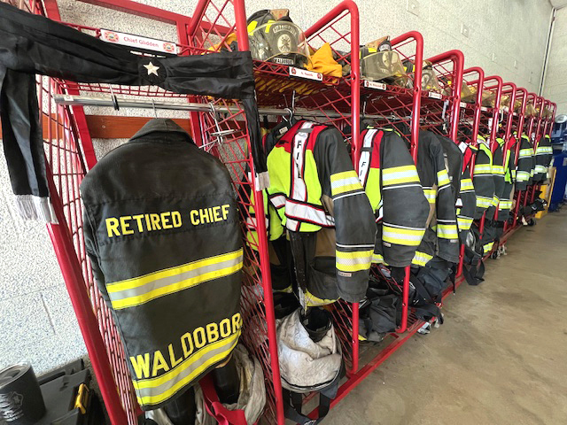 Dick Glidden's turnout gear hangs in his locker at the Waldoboro fire station next to the gear of Waldoboro's active firefighters on Saturday, Sept. 20. Glidden passed away Sept. 16, five days after he was diagnosed with terminal cancer. (Photo courtesy Shawna Kurr)