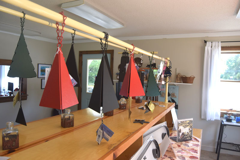 Buoy bells line the shelves of the new retail location of North Country Wind Bells in Waldoboro. Peggy and Ron Davis, who bought the business in 2024, felt that the brand needed to continue on the coast of Maine after learning it was for sale. (Christina Wallace photo)