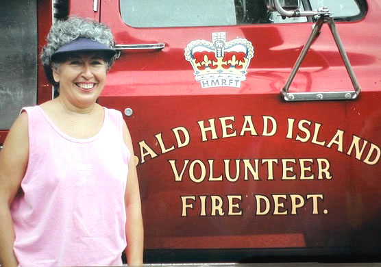 Juanita Roushdy stands next to a Bald Head Island Volunteer Fire Department fire truck. Having moved to Bald Head Island, N.C. for her first retirement in 2001, Roushdy served on the department for nine years. Department members had a special decal made for her truck, HMFRT. When I asked them what it meant, they laughed and said Her Majestys Royal Fire Truck! Roushdy said. So much for humor! (Courtesy photo)