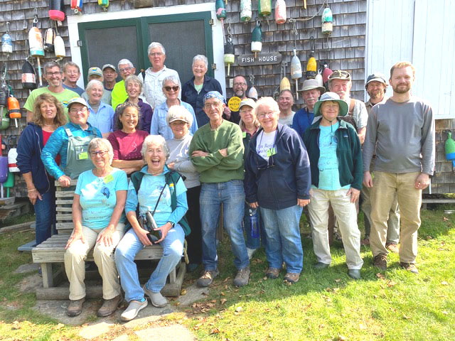A group of Hog Island volunteers, including Juanita Roushdy, take a break in front of the Fish House. The National Audubon Society pays professional staff members to work on the island. The Friends of Hog Island raises money to support camp operations and coordinates volunteer labor during the season. (Courtesy photo)