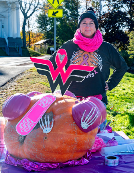 Mindy Starr-Pfahler poses with her breast cancer-themed pumpkin during Damariscotta Pumpkinfest on Oct. 11. Starr-Pfahler, who works at Sheepscot River Pottery in Edgecomb, is a longtime pumpkin artist for the annual festival. (Bisi Cameron Yee photo)