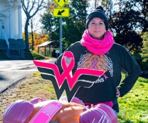 Mindy Starr-Pfahler poses with her breast cancer-themed pumpkin during Damariscotta Pumpkinfest on Oct. 11. Starr-Pfahler, who works at Sheepscot River Pottery in Edgecomb, is a longtime pumpkin artist for the annual festival. (Bisi Cameron Yee photo)