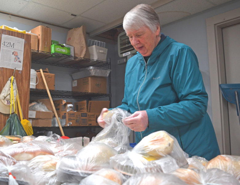 Carol Brazier prepares bread and deli products for distribution at the Waldoboro Food Pantry on Tuesday, Oct. 21. Brazier has volunteered at the pantry for over eight years. (Ali Juell photo)