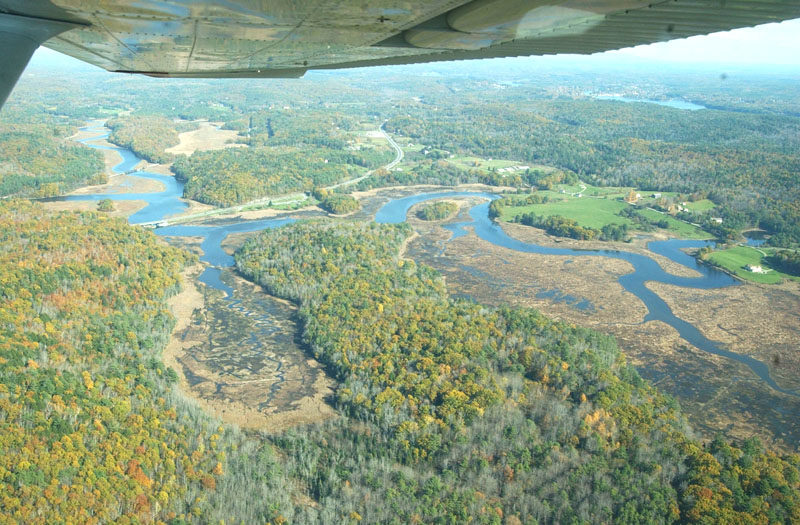 The full 200-plus acre Sherman Marsh can be seen in this aerial photo from 2008. In the weeks that followed the October 2005 storm that washed away Sherman Lake, locals debated the pros and cons of reestablishing the man-made lake. In late January 2006, the Maine Department of Transportation announced the state would not rebuild the dam, allowing the marsh to return to its natural state. (Courtesy photo) condition