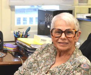Wiscasset Area Chamber of Commerce Executive Manager Patricia Cloutier sits at her desk at the Lincoln County Regional Planning Commission office last week. After 10 years of greeting visitors and employees as they enter the building, Cloutier retired from the position Wednesday, Oct. 1. (Charlotte Boynton photo)