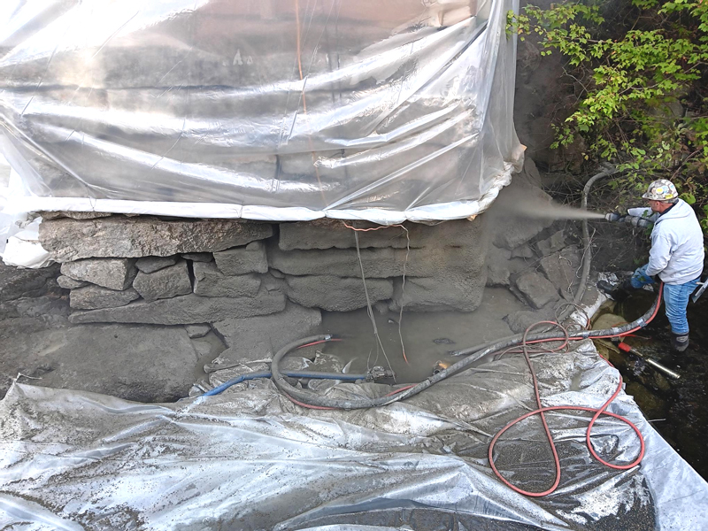 A worker from Knowles Industrial Services repairs the foundation wall of the Pemaquid Mill. (Photo courtesy Knowles Industrial Services)