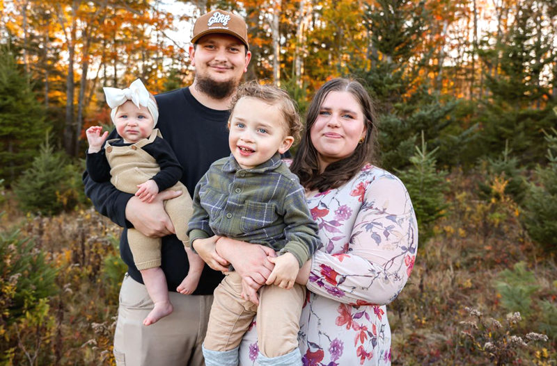 Brian and Rylee Dunn and their children Salem and Jameson stand in Green Acre Tree Farm in Edgecomb. The family moved from Arizona to take over the decades-old tree farm in March. (Ali Juell photo)